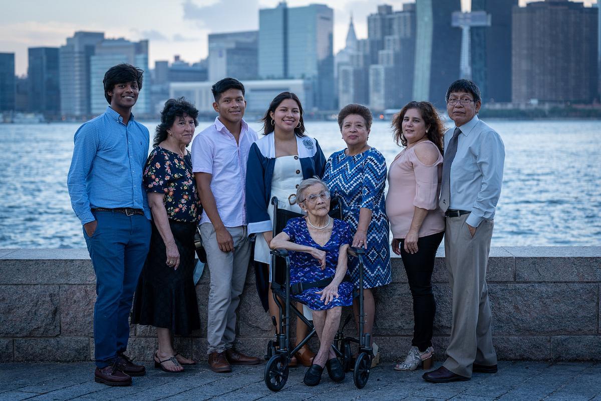Family portrait with the Manhattan skyline at golden hour